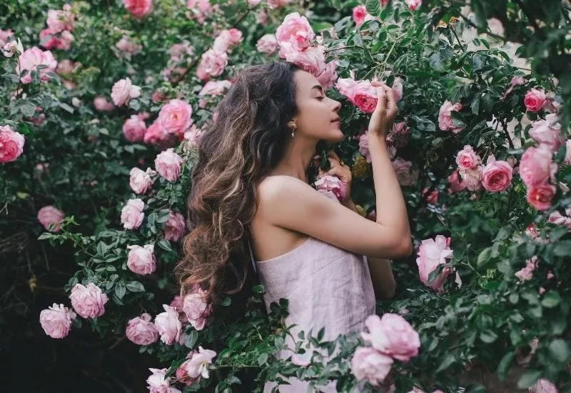 Girl smelling the Best Fragrant Roses