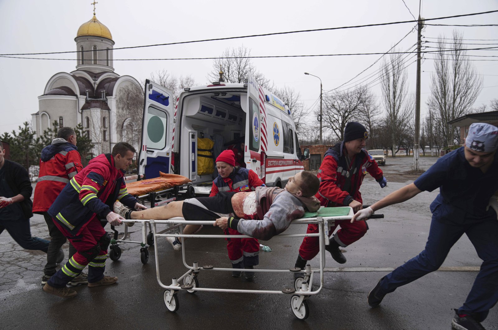 Medical staff carrying injured in port city of Mariupol in Ukraine