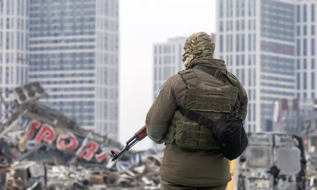 Ukrainian soldier standing on debris