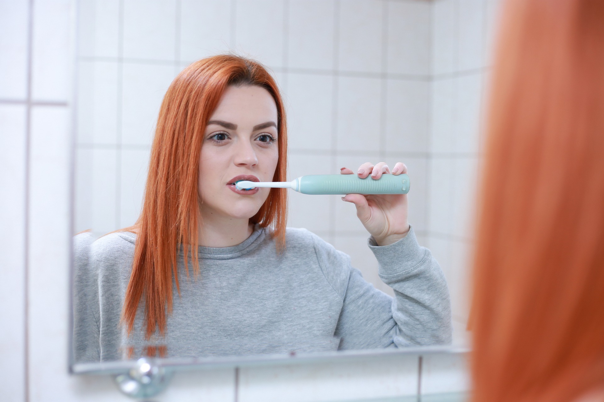 A girl is brushing her teeth