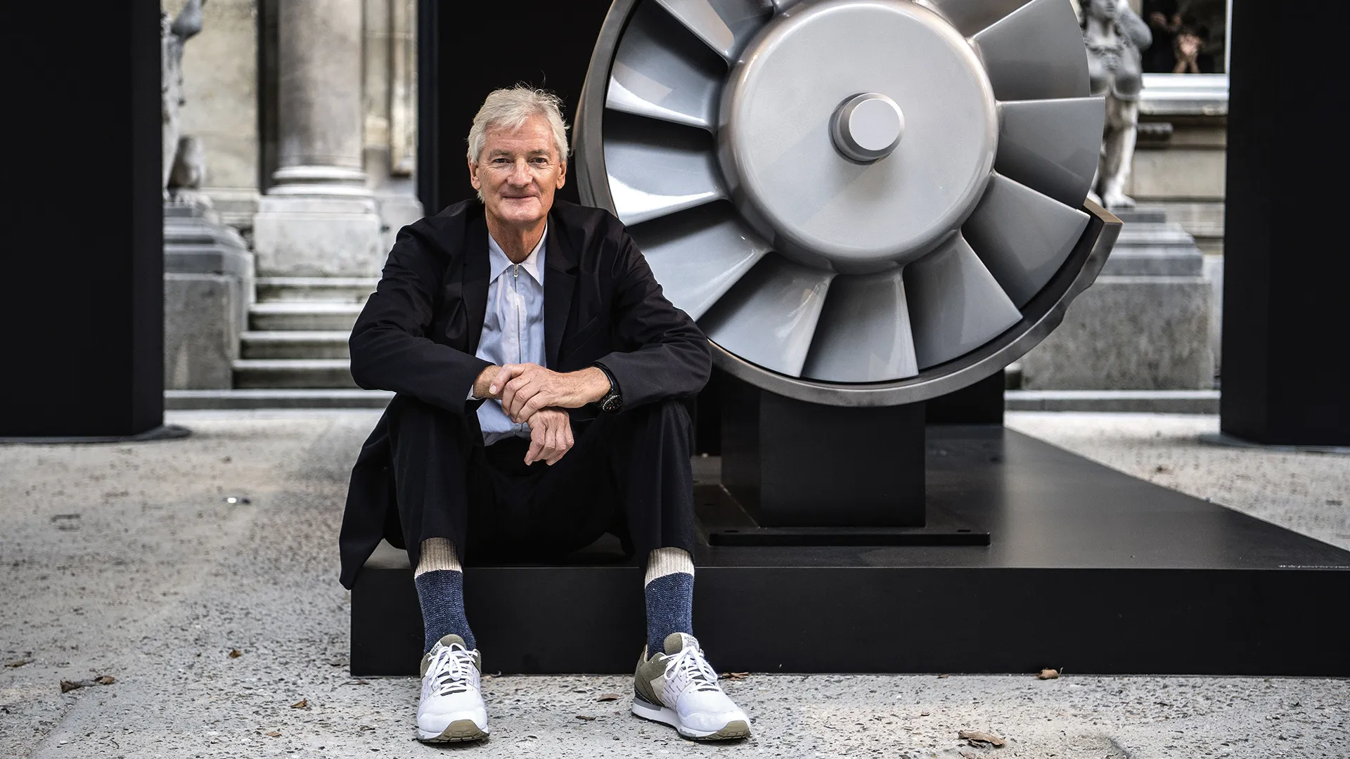 James Dyson sitting besides a machine