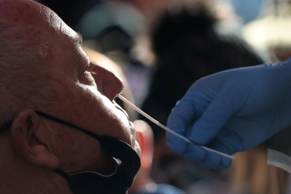 A person takes a COVID-19 test in Times Square