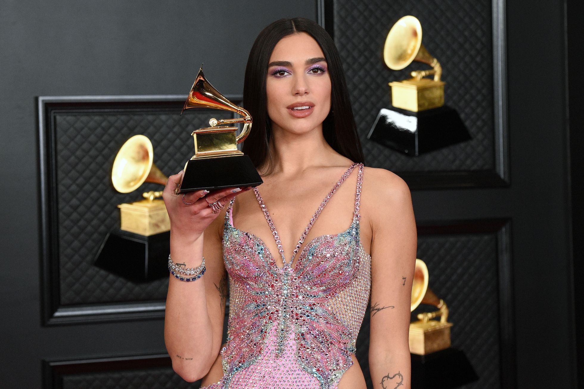 Dua Lipa poses with the Grammy she won for album ‘Future Nostalgia.'