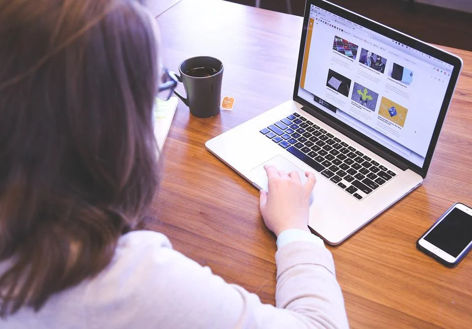 A girl is typing on laptop