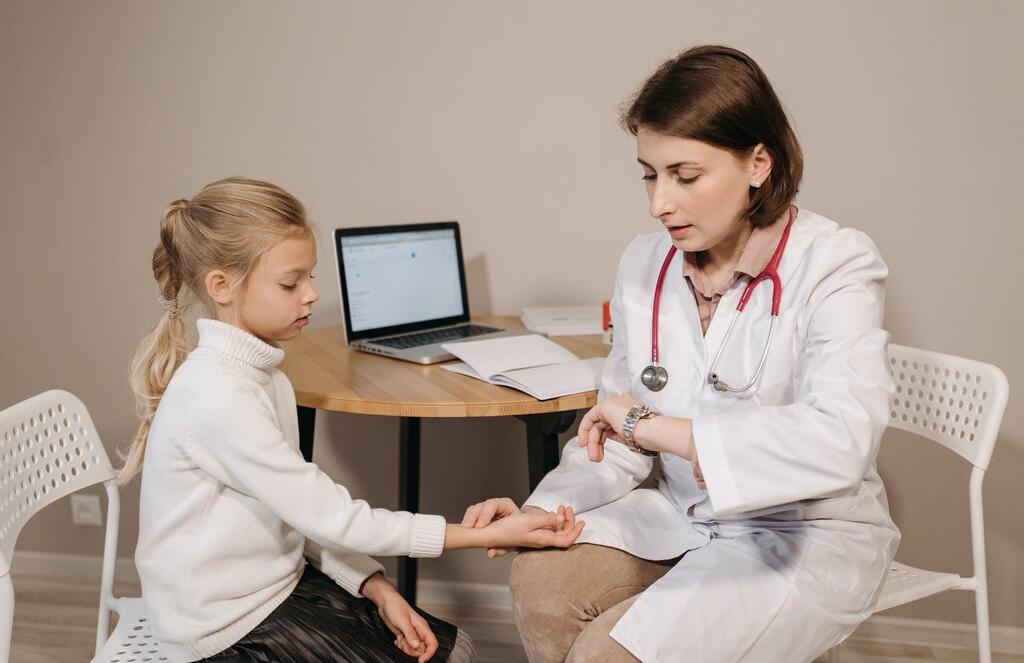 a doctor is checking a kid